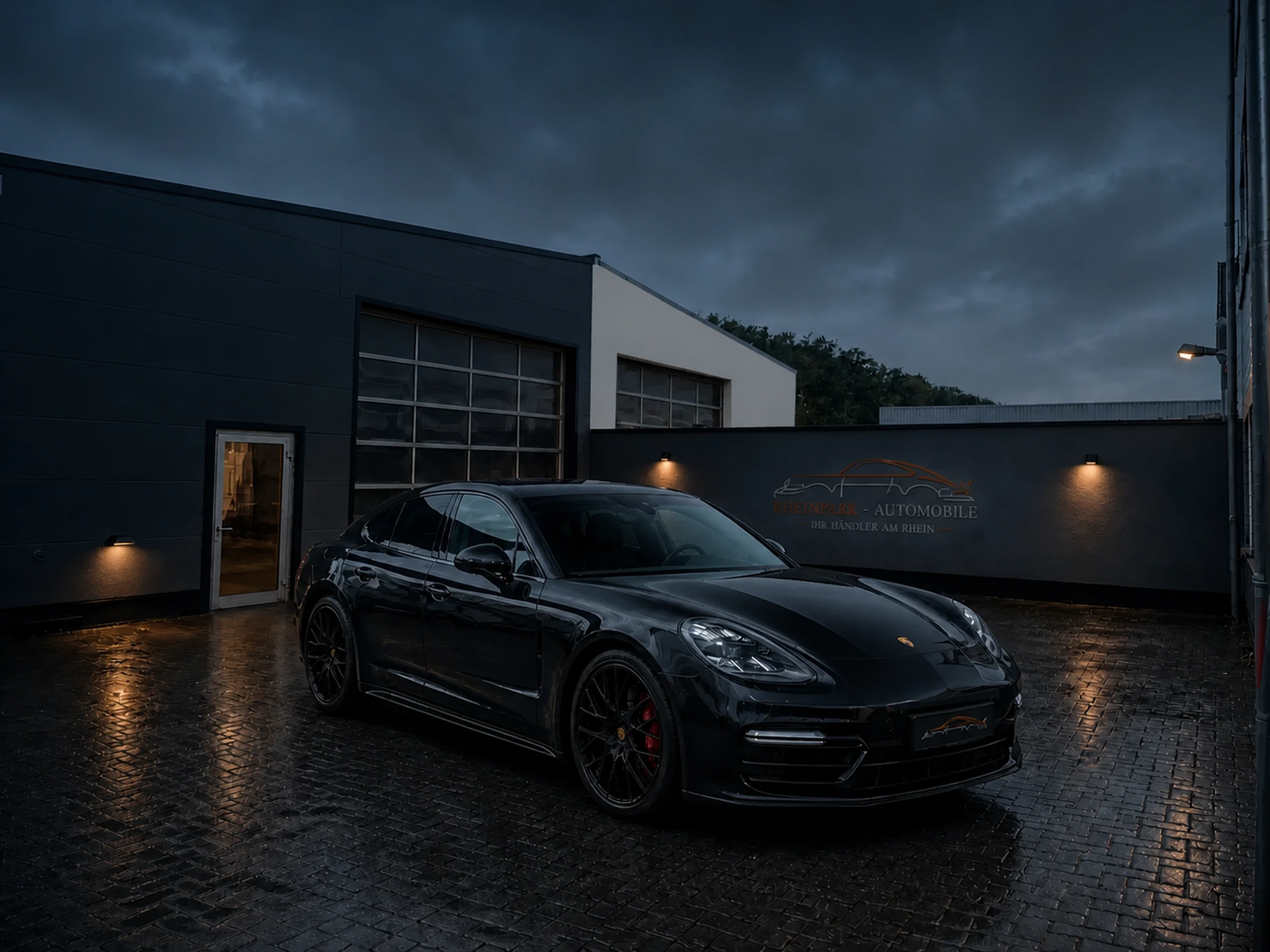 Bildkomposition: schwarzer Porsche Panamera auf dem Außenplatz von RheinPark Automobile in Köln